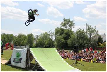 Pictured: A stunt rider for Dialed BMX Shows performs for our students