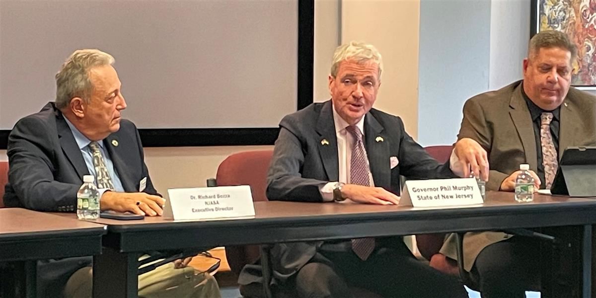 Left, NJASA Executive Director Dr. Richard Bozza; right, NJASA President Tony Trongone; listen as New Jersey Governor Phil Murphy addresses the Nov. 2 LEE meeting at NJASA Headquarters.  